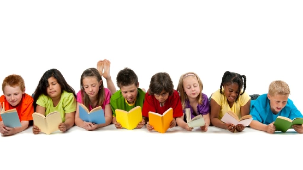 A group of diverse children reading a book.