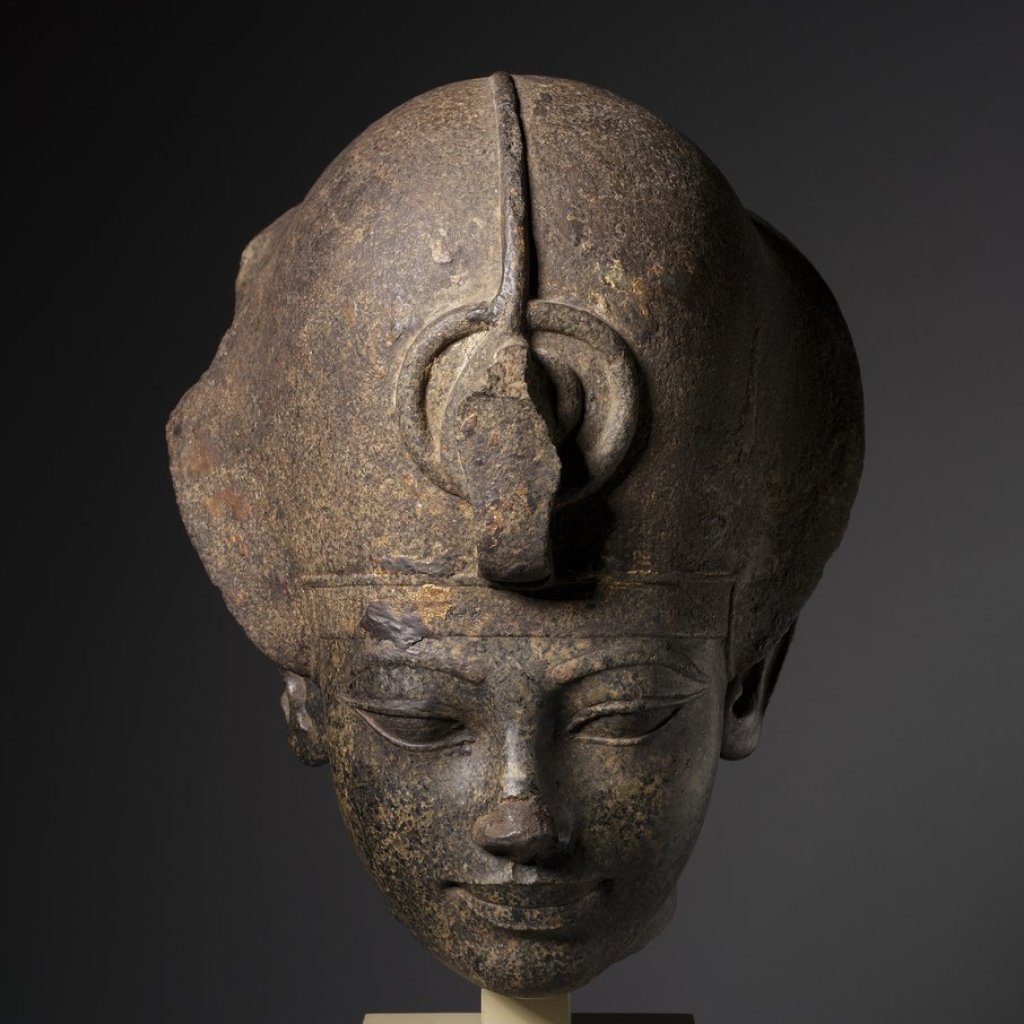 lossy-page1-906px-Egypt,_New_Kingdom,_Dynasty_18,_reign_of_Amenhotep_III_-_Head_of_Amenhotep_III_Wearing_the_Blue_Crown_-_1952.513_-_Cleveland_Museum_of_Art.tif